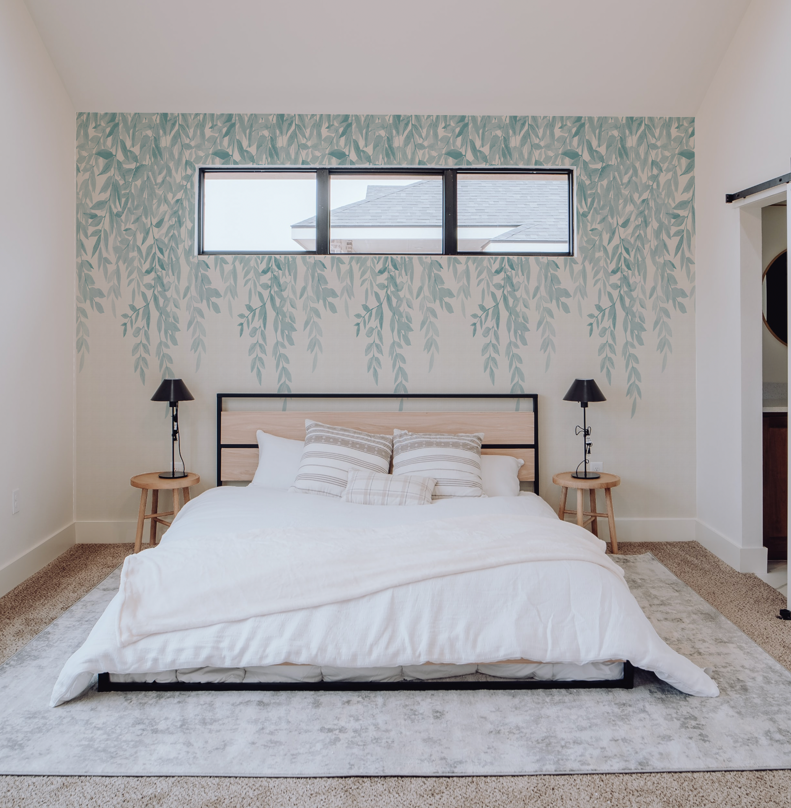 Teal accent wallpaper installation in bedroom